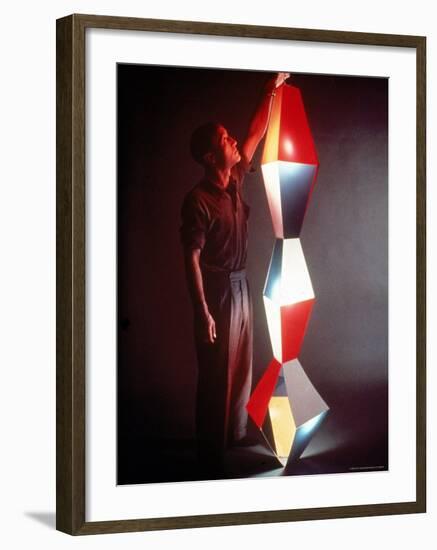 Japanese American Sculptor Isamu Noguchi Adjusting a Light Sculpture He Designed-Eliot Elisofon-Framed Premium Photographic Print