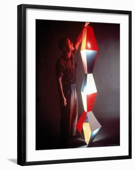 Japanese American Sculptor Isamu Noguchi Adjusting a Light Sculpture He Designed-Eliot Elisofon-Framed Premium Photographic Print