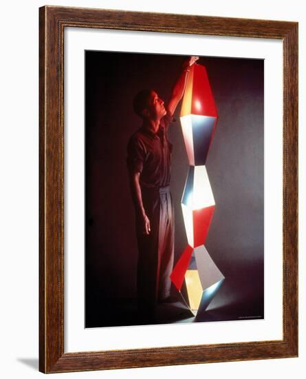 Japanese American Sculptor Isamu Noguchi Adjusting a Light Sculpture He Designed-Eliot Elisofon-Framed Premium Photographic Print