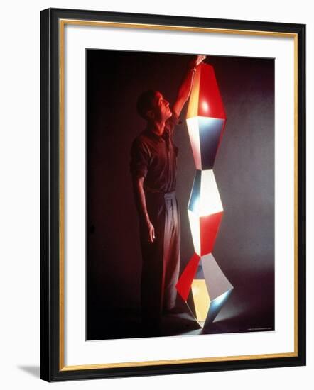 Japanese American Sculptor Isamu Noguchi Adjusting a Light Sculpture He Designed-Eliot Elisofon-Framed Premium Photographic Print