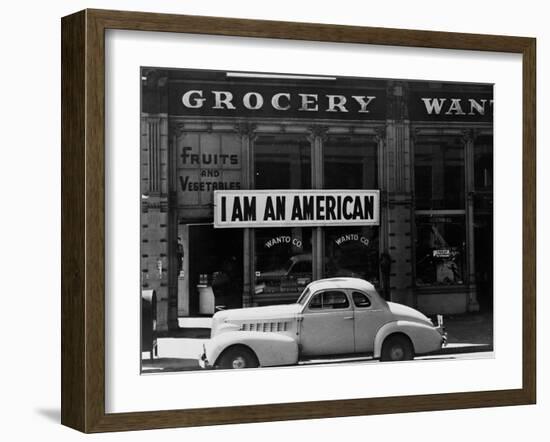 Japanese American shop owner in Oakland, CA hopes to avoid internment after Pearl Harbor, 1942-Dorothea Lange-Framed Photographic Print