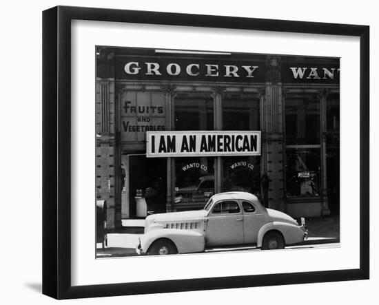 Japanese American shop owner in Oakland, CA hopes to avoid internment after Pearl Harbor, 1942-Dorothea Lange-Framed Photographic Print