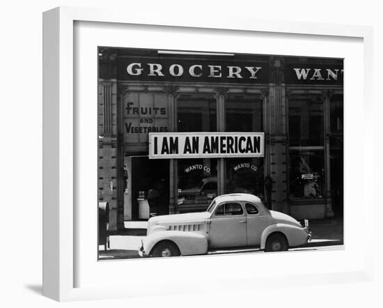 Japanese American shop owner in Oakland, CA hopes to avoid internment after Pearl Harbor, 1942-Dorothea Lange-Framed Photographic Print