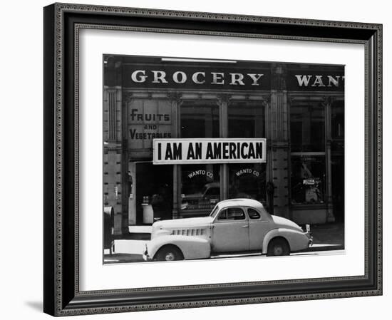 Japanese American shop owner in Oakland, CA hopes to avoid internment after Pearl Harbor, 1942-Dorothea Lange-Framed Photographic Print