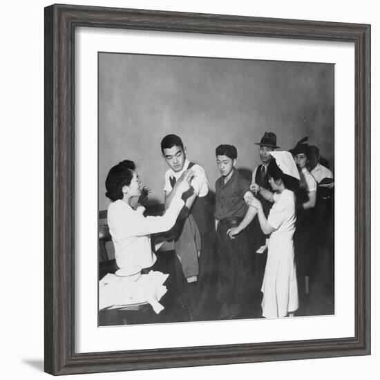 Japanese Americans queue for inoculation before internment after the bombing of Pearl Harbor, 1942-Dorothea Lange-Framed Photographic Print