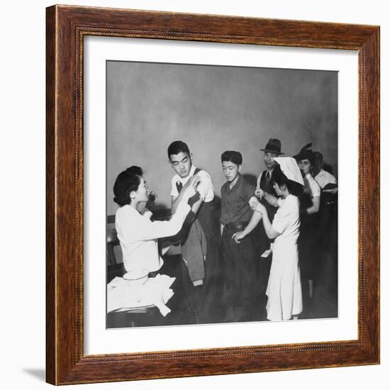 Japanese Americans queue for inoculation before internment after the bombing of Pearl Harbor, 1942-Dorothea Lange-Framed Photographic Print