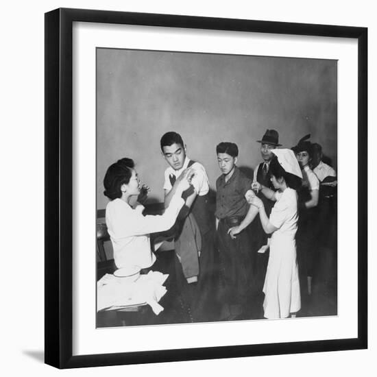 Japanese Americans queue for inoculation before internment after the bombing of Pearl Harbor, 1942-Dorothea Lange-Framed Photographic Print