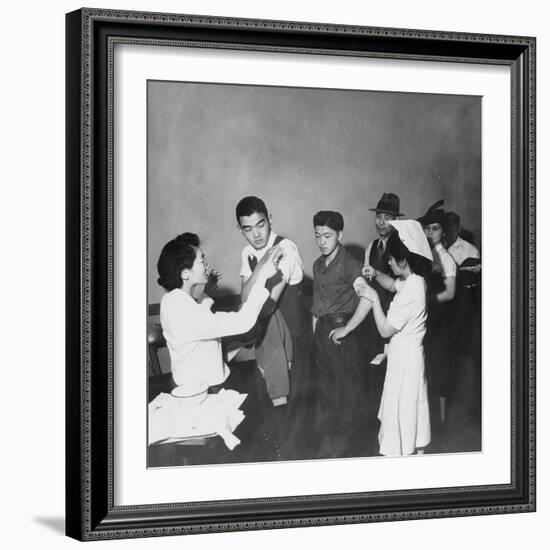 Japanese Americans queue for inoculation before internment after the bombing of Pearl Harbor, 1942-Dorothea Lange-Framed Photographic Print