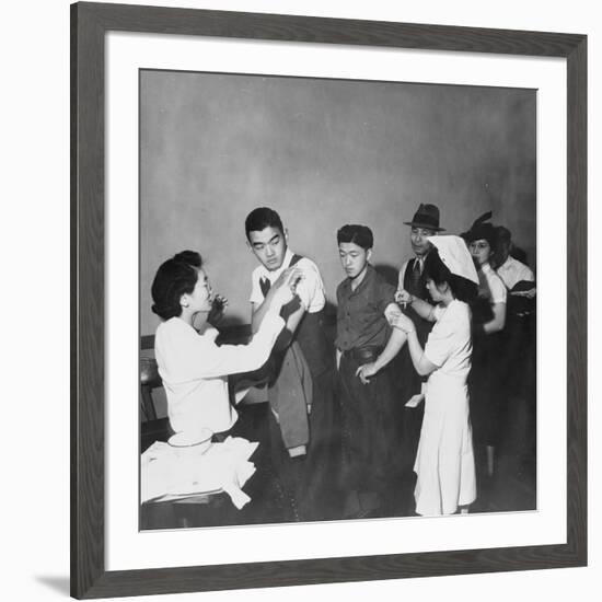 Japanese Americans queue for inoculation before internment after the bombing of Pearl Harbor, 1942-Dorothea Lange-Framed Photographic Print