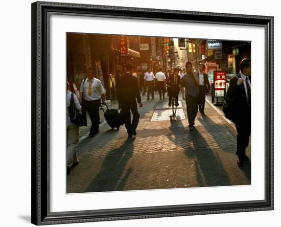 Japanese Commuters Walk Through a Tokyo Street on Their Way to the Train Stations-David Guttenfelder-Framed Photographic Print