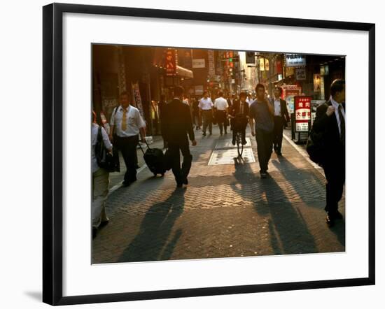 Japanese Commuters Walk Through a Tokyo Street on Their Way to the Train Stations-David Guttenfelder-Framed Photographic Print