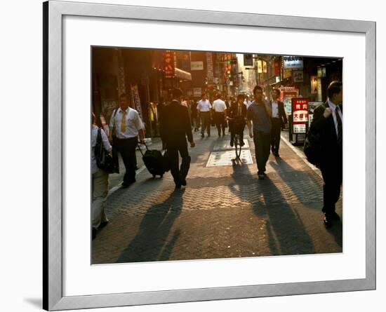 Japanese Commuters Walk Through a Tokyo Street on Their Way to the Train Stations-David Guttenfelder-Framed Photographic Print