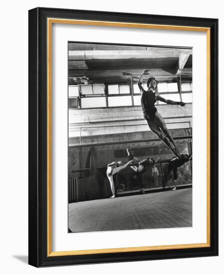 Jean Babilee, Star of Ballets Des Champs Elysees, Leaping During Practice as Other Dancers Watch-Gjon Mili-Framed Photographic Print