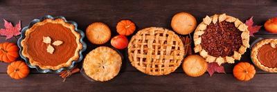 Assorted Homemade Fall Pies. Top View Table Scene on a Dark Wood Banner Background.-jenifoto-Photographic Print