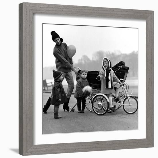 Jenny Boyd in Light Pants and Boots with Children, 1960s-John French-Framed Giclee Print