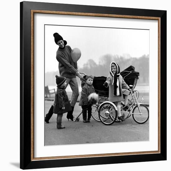 Jenny Boyd in Light Pants and Boots with Children, 1960s-John French-Framed Giclee Print