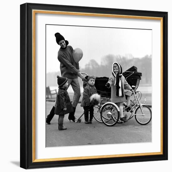 Jenny Boyd in Light Pants and Boots with Children, 1960s-John French-Framed Giclee Print