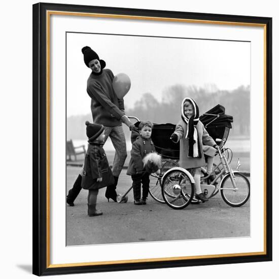 Jenny Boyd in Light Pants and Boots with Children, 1960s-John French-Framed Giclee Print