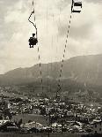 Man Riding Chair Lift Above Town-Jerry Cooke-Photographic Print