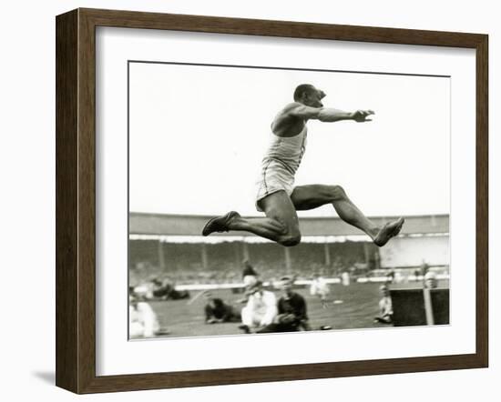 Jesse Owens in Action at the Long Jump During the Berlin Olympics, 1936-null-Framed Photographic Print