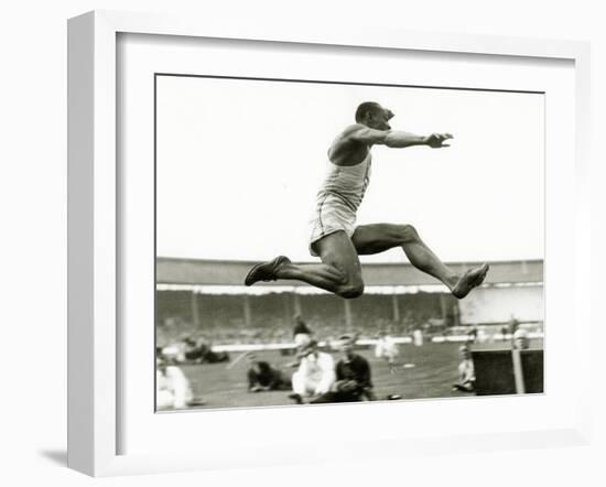 Jesse Owens in Action at the Long Jump During the Berlin Olympics, 1936-null-Framed Photographic Print