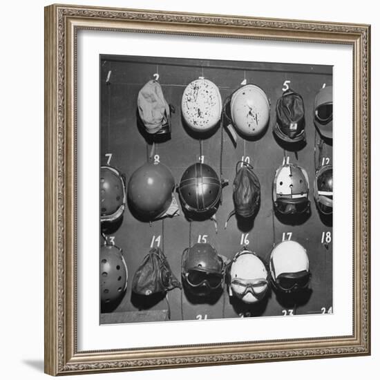 Jet Pilot Helmets and Goggles Hanging on Hooks-Charles E^ Steinheimer-Framed Photographic Print