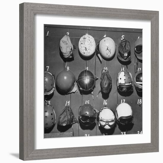 Jet Pilot Helmets and Goggles Hanging on Hooks-Charles E^ Steinheimer-Framed Photographic Print