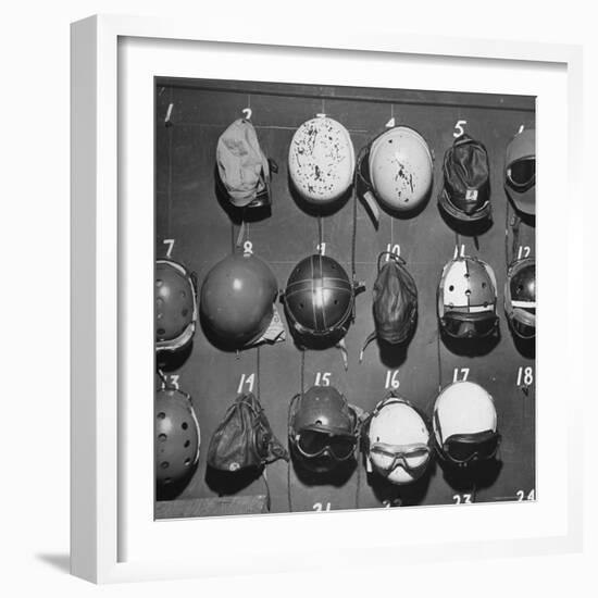 Jet Pilot Helmets and Goggles Hanging on Hooks-Charles E^ Steinheimer-Framed Photographic Print