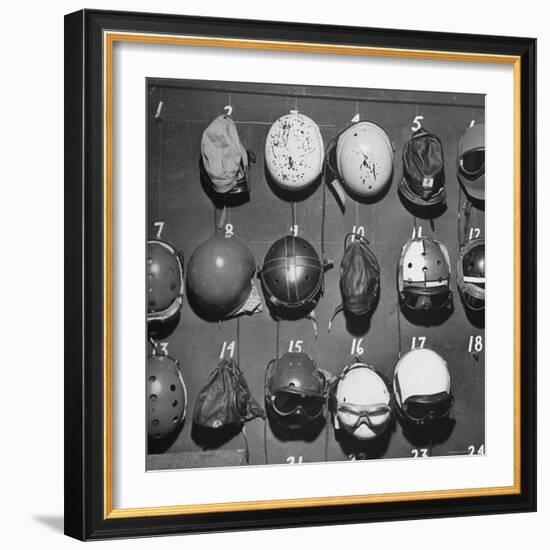 Jet Pilot Helmets and Goggles Hanging on Hooks-Charles E^ Steinheimer-Framed Photographic Print