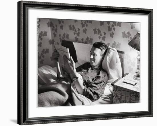 Jimmy Stewart, Dressed in Silk Pajamas Reading Magazine in Bed in Family Home-Peter Stackpole-Framed Premium Photographic Print