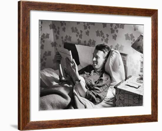 Jimmy Stewart, Dressed in Silk Pajamas Reading Magazine in Bed in Family Home-Peter Stackpole-Framed Premium Photographic Print