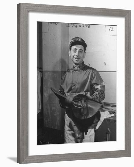 Jockey Johnny Longden Smiling and Holding Saddle-Martha Holmes-Framed Premium Photographic Print