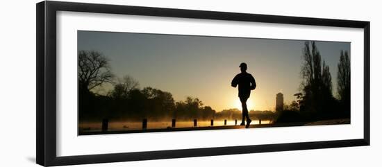 Jogger Silhouetted Against the Rising Sun as He Runs Past the Serpentine Lake in Hyde Park, London-null-Framed Photographic Print