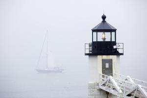 A Sailboat Passing Marshall Point Lighthouse in Port Clyde, Maine by John Burcham