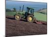 John Deere Tractor with a Rotivator on a Sloping Field in Spring, at Holcombe, Devon, England, UK-Ian Griffiths-Mounted Photographic Print