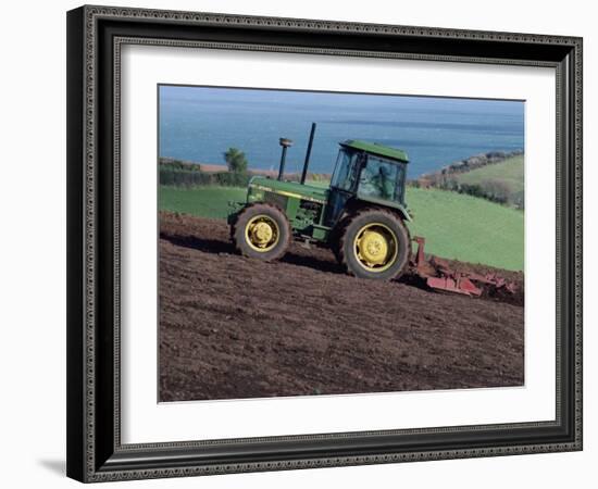 John Deere Tractor with a Rotivator on a Sloping Field in Spring, at Holcombe, Devon, England, UK-Ian Griffiths-Framed Photographic Print