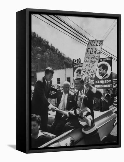 John F. Kennedy and Franklin D. Roosevelt Jr. Shaking Hands with Boy During Parade-Hank Walker-Framed Premier Image Canvas