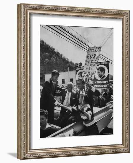 John F. Kennedy and Franklin D. Roosevelt Jr. Shaking Hands with Boy During Parade-Hank Walker-Framed Photographic Print