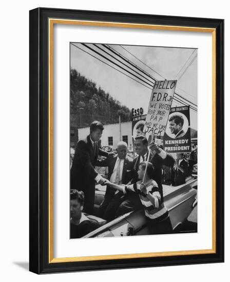 John F. Kennedy and Franklin D. Roosevelt Jr. Shaking Hands with Boy During Parade-Hank Walker-Framed Photographic Print