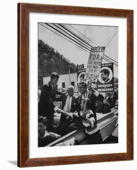 John F. Kennedy and Franklin D. Roosevelt Jr. Shaking Hands with Boy During Parade-Hank Walker-Framed Photographic Print