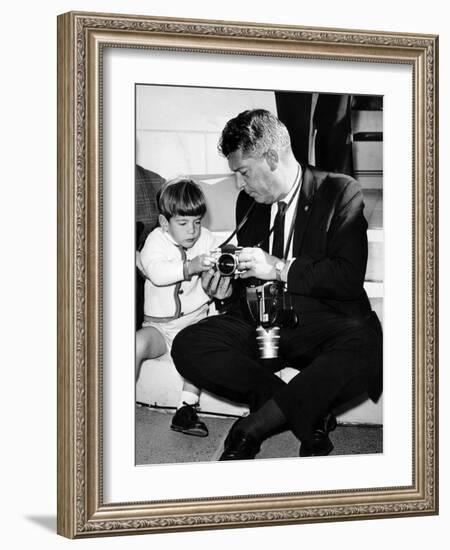 John F Kennedy Jr Looks at Cameras of White House Photographer Capt Cecil Stoughton, Nov 11, 1963-null-Framed Photo