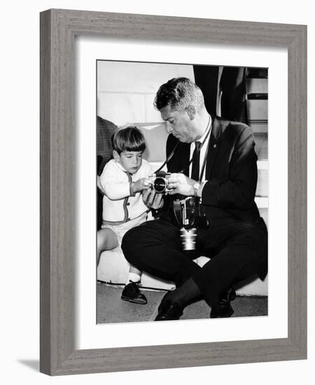 John F Kennedy Jr Looks at Cameras of White House Photographer Capt Cecil Stoughton, Nov 11, 1963-null-Framed Photo