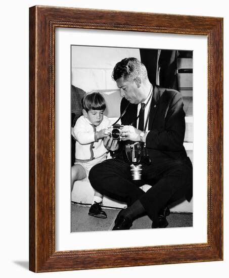 John F Kennedy Jr Looks at Cameras of White House Photographer Capt Cecil Stoughton, Nov 11, 1963-null-Framed Photo