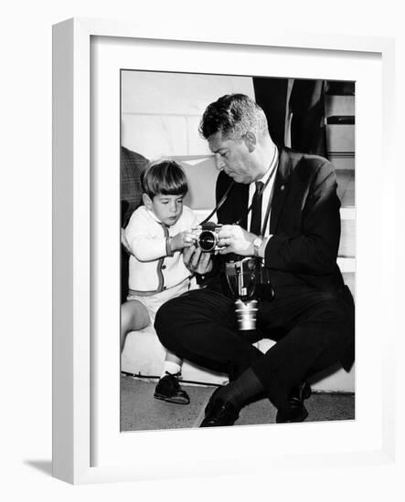 John F Kennedy Jr Looks at Cameras of White House Photographer Capt Cecil Stoughton, Nov 11, 1963-null-Framed Photo