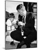 John F Kennedy Jr Looks at Cameras of White House Photographer Capt Cecil Stoughton, Nov 11, 1963-null-Mounted Photo