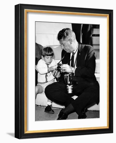 John F Kennedy Jr Looks at Cameras of White House Photographer Capt Cecil Stoughton, Nov 11, 1963-null-Framed Photo