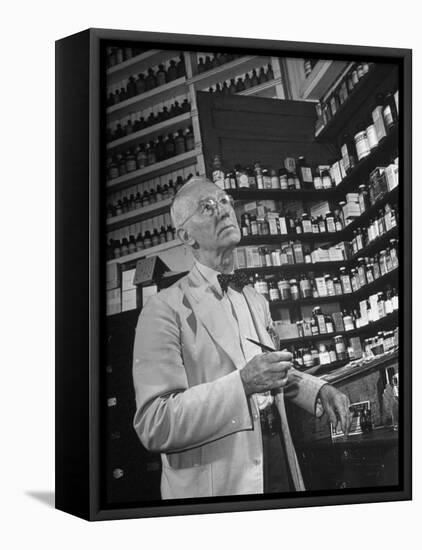 John Rogers in the Prescription Room of His Old-Fashioned Pharmacy-null-Framed Premier Image Canvas