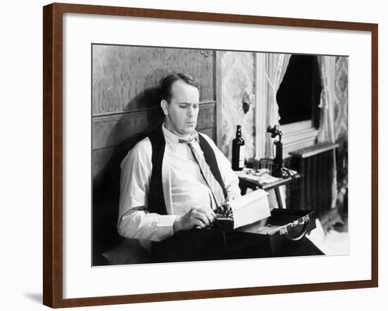 Journalist Sitting on His Bed with a Typewriter, Typing-null-Framed Photo