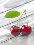 A Pair of Cherries with a Leaf on a Wooden Table-Jürgen Klemme-Framed Photographic Print