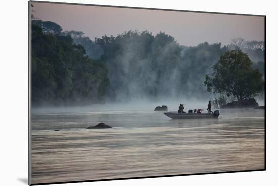 Kafue NP, Zambia. Tourist On A Boat Tour Of Kafue River Enjoys Morning Mist Before The Sun Rises-Karine Aigner-Mounted Photographic Print